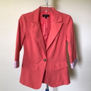 Bright pink blazer and polka dot cuffs